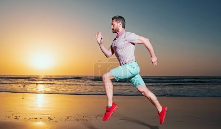 Photo for Young athletic and fit american sport man doing running workout on sunset at the beach training jogging barefoot in healthy lifestyle concept - Royalty Free Image