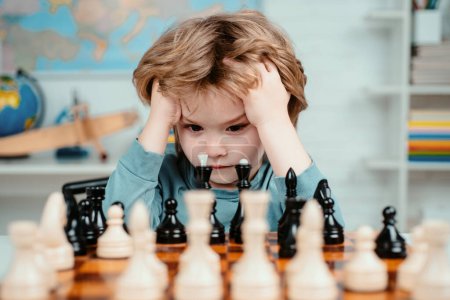 Photo for Boy think or plan about chess game, vintage style for education concept. Child and childhood. Clever concentrated and thinking child while playing chess - Royalty Free Image