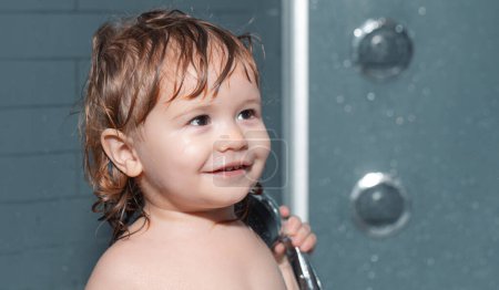 Photo for Cute child playing in bathtube. Funny happy baby bathes in bathtub with water and foam. Kids hygiene - Royalty Free Image
