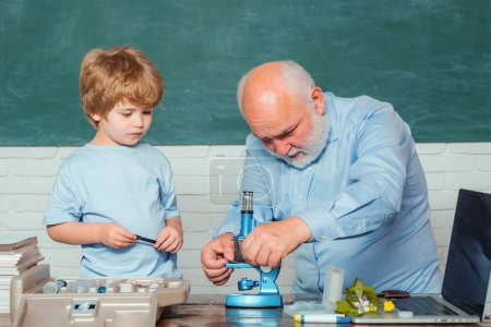 Photo for School. Old bearded teacher in the classroom. My Microbiology experiment. Funny teacher in the classroom. Kid from primary school. Science. Back to school - Royalty Free Image