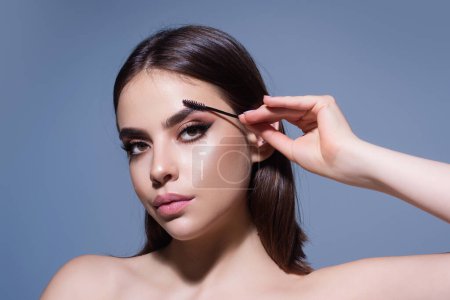 Photo for Beautiful woman with dark eyebrows hold eyebrow brush. Eyebrows lamination. Brow beauty procedures. Combs eyebrows with a brus, eyebrow eye line - Royalty Free Image