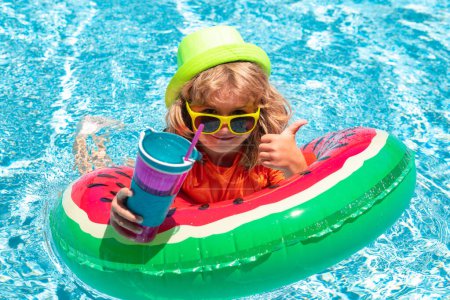 Photo for Children in the swimming pool. Healthy kids lifestyle. Happy kid playing with colorful swim ring in swimming pool on summer day. Child water vacation. Children play in tropical resort - Royalty Free Image