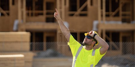 Photo for Construction builder in building uniform on buildings construction background. Builder at the construction site. Man worker with helmet on construction site. Bilder in hardhat - Royalty Free Image