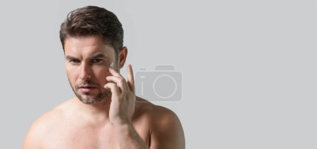 Photo for Caucasian beauty man use moisturizing face balm for healthy skin, male skincare concept. Male beauty skin care portrait. Healthy clean face after shaving, facial treatment, banner poster, copy space - Royalty Free Image