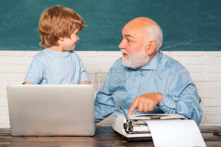 Photo for Portrait of confident old male teacher. Teacher helping his teen pupil on education class. Young boy doing his school homework with his father - Royalty Free Image