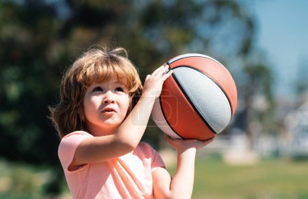 Photo for Kid playing basketball. Child boy face preparing for basketball shooting. Best sport for kids - Royalty Free Image