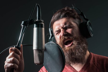 Photo for Portrait of man in recording studio. Expression face close up. Music performance vocal. Singer singing song with a microphone - Royalty Free Image