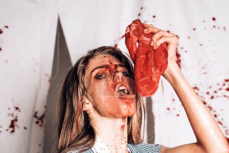 Photo for Animal hunger. meatman in butcher shop, butchery. cannibalism. donation and donar. bloody halloween. anatomy. zombie. medical transplantation. woman in blood. human internal organ trade Ribeye steak - Royalty Free Image