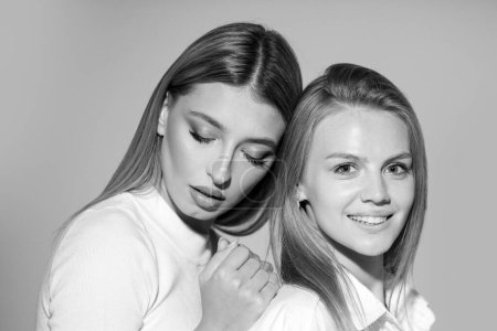 Foto de Portrait of two cheerful young women. Two beautiful young women with perfect skin in the studio. Lesbians lgbt couple - Imagen libre de derechos