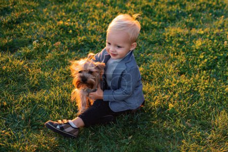 Photo for Happy childhood. Sweet childhood memories. Child play with yorkshire terrier dog. Toddler boy enjoy leisure with dog friend. Small baby toddler walk with dog. True friendship. Best friends forever. - Royalty Free Image