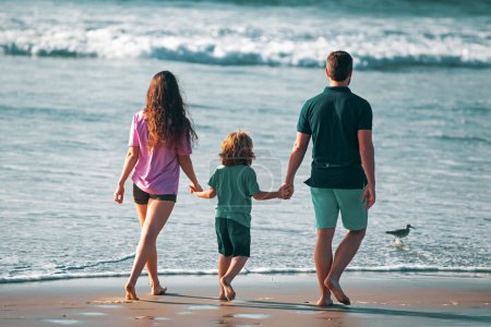 Photo for Back view of family on the beach. People having fun on summer vacation. Father, mother and child holding hands against blue sea. Holiday travel. Freedom carefree people concept - Royalty Free Image