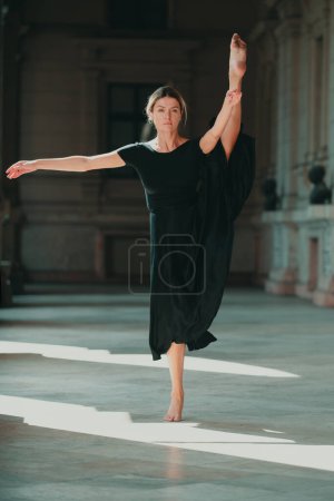 Photo for Ballet dancer. Flexible stretch fit woman body. Young girl doing stretching workout. Fitness model exercising in morning outdoors. Dance studio - Royalty Free Image