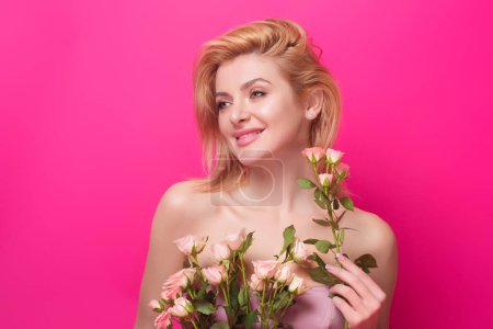 Photo for Slim sexy beautiful woman with naked shoulder hold red roses, isolated on studio background. Portrait of sensual girl with flowers - Royalty Free Image