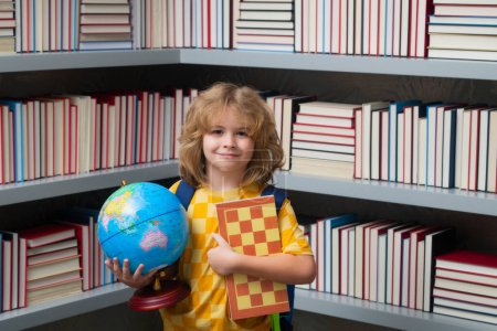 Photo for School boy with world globe and chess, childhood. School kid student learning, study language or literature at school. Elementary school child. Portrait of nerd pupil studying - Royalty Free Image