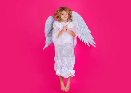 Photo for Angel child jump, kids jumping, full body in movement. Cute kid with angel wings isolated on pink studio background. Little angel, valentines day. Angelic kids - Royalty Free Image