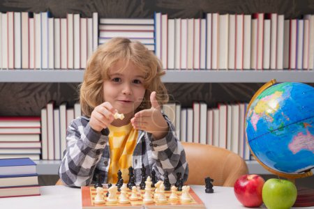 Photo for Play chess. Chess for intelligent kid. Child genius, smart pupil playing logic board game. Clever school boy thinking about chess - Royalty Free Image