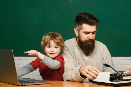 Photo for Little students. Teacher and kid. Daddy play with schoolboy. Daddy and his little son. Childhood and parenthood. Young boy doing his school homework with his father - Royalty Free Image