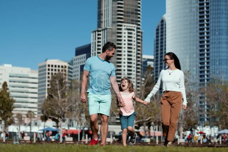 Photo for Happy american family with little child son walking in modern urban city - Royalty Free Image