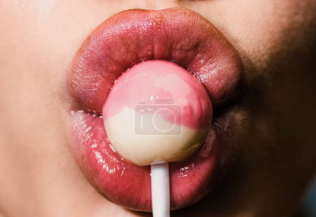 Photo for Sexy girl sucks lollipop, close up. Suck lolli pop concept. Woman sucking cute sweet candy closeup lips tongue. Sexy sweet dreams. Female mouth licks chupa chups - Royalty Free Image