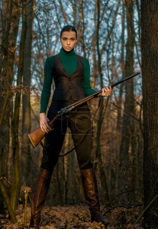 Photo for Successful hunt. hunting sport. girl with rifle. chase hunting. Gun shop. military fashion. achievements of goals. woman with weapon. Target shot. hunter in forest. Hunter in fall hunting season. - Royalty Free Image