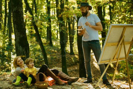 Photo for Capture moment. Beauty of nature. Bearded man woman and son relax autumn nature. Drawing from life. Painter artist with family relaxing in forest. Art concept. Painting in nature. Start new picture. - Royalty Free Image