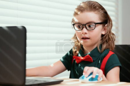 Photo for Online remote learning. School kids with computer having video conference chat with teacher in class. Child studying at home. Homeschooling concept - Royalty Free Image