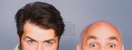 Photo for Two surprised men holding empty paper. Presentation. Copyspace. Old and young, father son. Surprised senior man and funny man holding empty paper. Copyspace. Season sales - Royalty Free Image