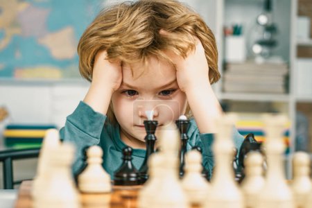 Photo for Intelligent, smart ass kids. Games good for brain intelligence concept. Clever concentrated and thinking child while playing chess. Kids early development - Royalty Free Image