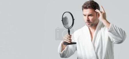Photo for Banner with copy space of man touching chin and skin. Handsome man touching face in front of the mirror in bath. Perfect skin. Man cosmetic, skin treatment. Hygiene and skin care male face - Royalty Free Image
