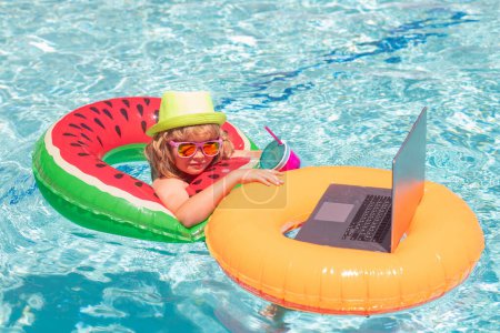Photo for Little freelancer, business man on summer travel. Kid working on laptop from the swimming pool. Summer business - Royalty Free Image