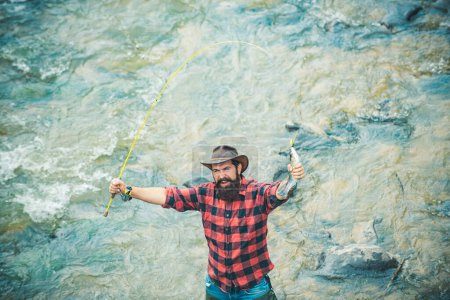 Photo for Excited amazed fisher man in water catching trout fish, top view. Fisherman man on river or lake with fishing rod - Royalty Free Image