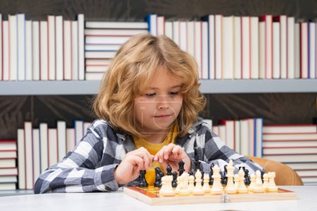 Photo for Chess school. Kid playing chess. Child thinking near chessboard. Learning and growing children, childgood. Kids early development - Royalty Free Image