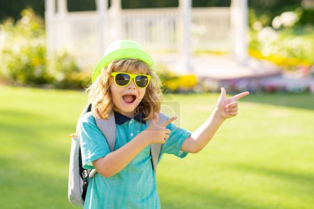 Photo for Excited kids in hat and summer sunglasses. Lifestyle portrait of cute kid outdoors. Summer kids outdoor portrait. Close-up face child playing outdoors in summer park - Royalty Free Image