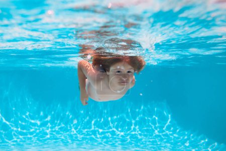 Photo for Child swim and dive underwater in the swimming pool. Summer vacation with children - Royalty Free Image