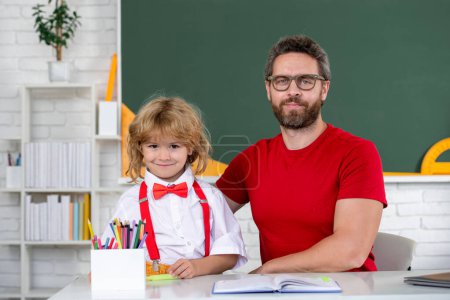 Photo for Back to school. Teacher and schoolboy learning in class at school. Elementary school student clever pupil - Royalty Free Image