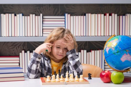 Photo for Chess school for kids. Clever child thinking about chess. Portrait of clever kid with chessboard. Boy play chess - Royalty Free Image