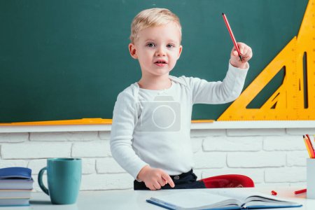 Photo for Happy school kids at lesson. Chalkboard copy space. Little ready to study. Portrait of Pupil in classroom - Royalty Free Image