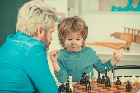 Photo for Happy Father and son. Games and activities for children. Man teacher play chess with preschooler child - Royalty Free Image