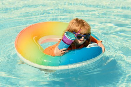 Photo for Children playing in the swimming pool. Kid summer vacation - Royalty Free Image