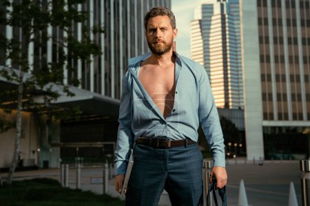 Photo for Attractive man in open shirt. Sexy businessman outdoors. Attractive man taking off shirt. Confident in his appealing. Handsome man fashion model - Royalty Free Image