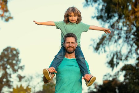 Photo for Happy father with son. Little boy on fathers shoulders - Royalty Free Image
