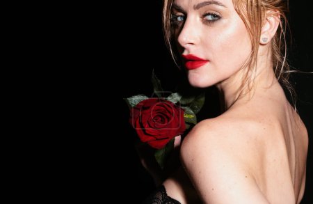 Photo for Fashion portrait of young beautiful woman with blue eyes and rose. Close-up portrait of a beautiful young girl with a red rose near face. Nofilter unaltered skin - Royalty Free Image