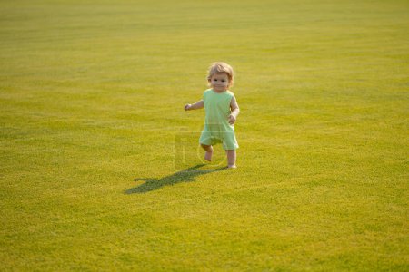 Photo for Healthy child. Baby boy toddler walking in a park on bright spring day - Royalty Free Image