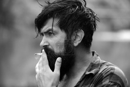 Photo for Portrait of handsome man smoking. Portrait of handsome man outdoor face. Confident fashion man hipster - Royalty Free Image