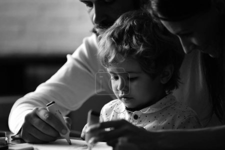 Photo for Family leisure, happy mother, father and little child. Happy loving family drawing at home. Children day - Royalty Free Image