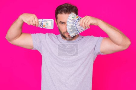 Photo for Portrait business man holding cash dollar bills over pink background. Big luck, banner. Dollar cash money concept. Rejoices to win cash. Man hold cash money. Financial luck and success - Royalty Free Image