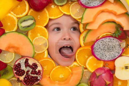 Foto de Healthy vitamins fruits. Kids face with mix of fresh frutis. Healthy nutrition food for kids - Imagen libre de derechos