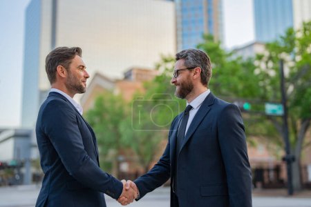 Business man shaking hands. Two businessmen handshake outdoor. Handshake business people. Motivation and inspiration for the two business man. Two business men discussed their strategy