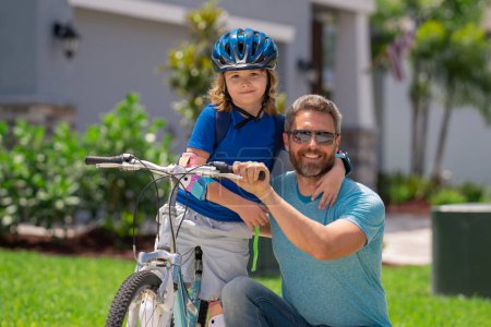 Photo for Fathers day. Father teaching son ride a bicycle. Father and son cycling on bike on summer day. Father playing with son outdoor. Father support child. Fathers love. Sporty kids - Royalty Free Image
