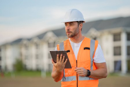 Photo for Engineer with tablet, building inspection. Portrait of builder in a construction site. Builder ready to build new house. Construction builder wear building uniform and helmet - Royalty Free Image